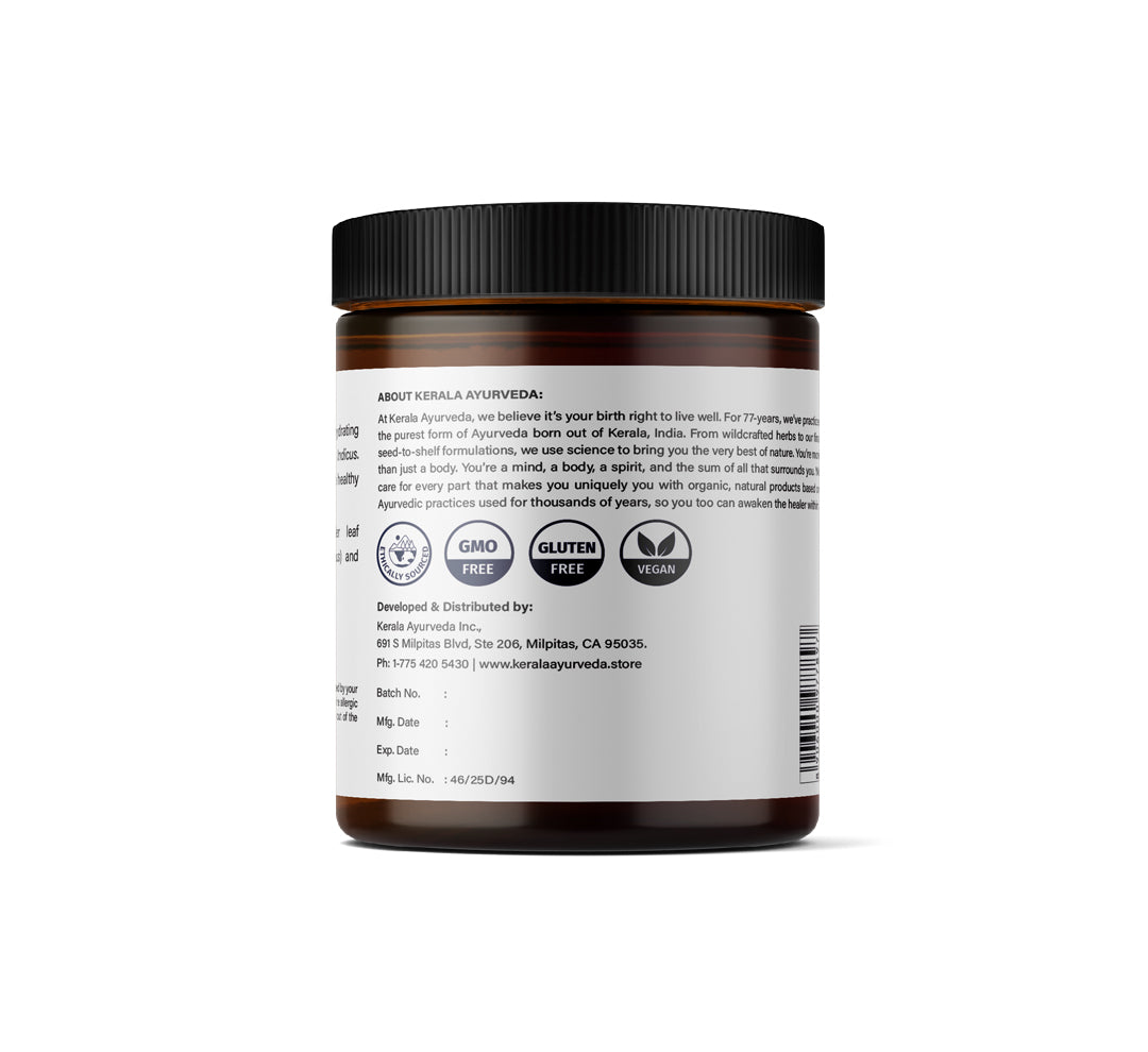 Back view of A jar of Kerala Ayurveda Calming Scalp and Body Oil with a label that includes the product description.