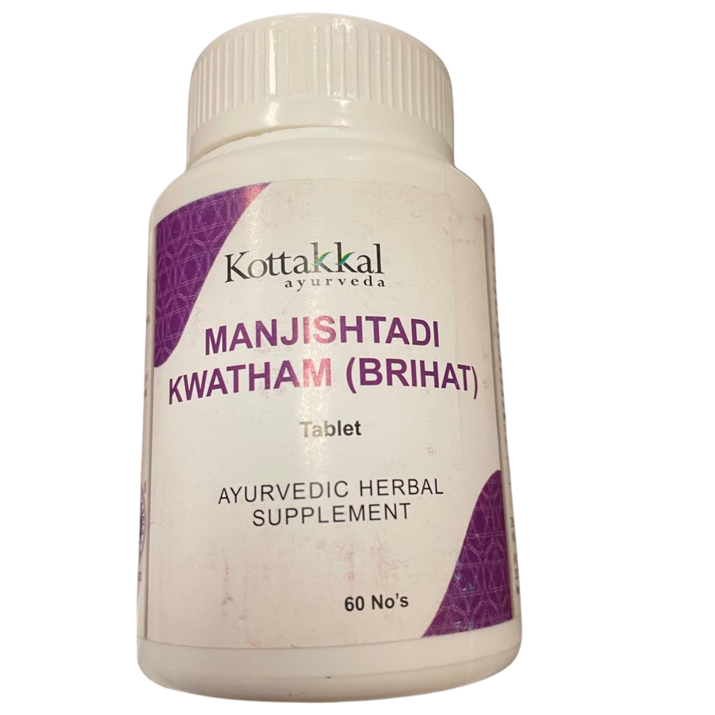 A bottle of KT Manjishthadi Kwatham 60 Tablets by Kottakkal Ayurveda. The label is predominantly white with purple and green text, and the bottle is sealed with a white cap.