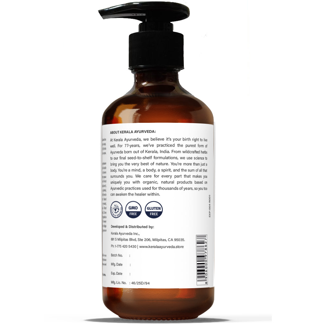 A view bottle of Tridoshic Massage Oil (Thriphaladi Thailam) with a pump dispenser, labeled with the brand details