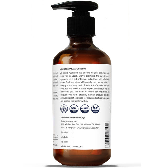 A clear bottle with a pump dispenser, labeled 'PHYTO-HYDRATION BODY OIL' along with the product name 'PINDA THAILAM'. The bottle shows the back label highlighting the product and brand details