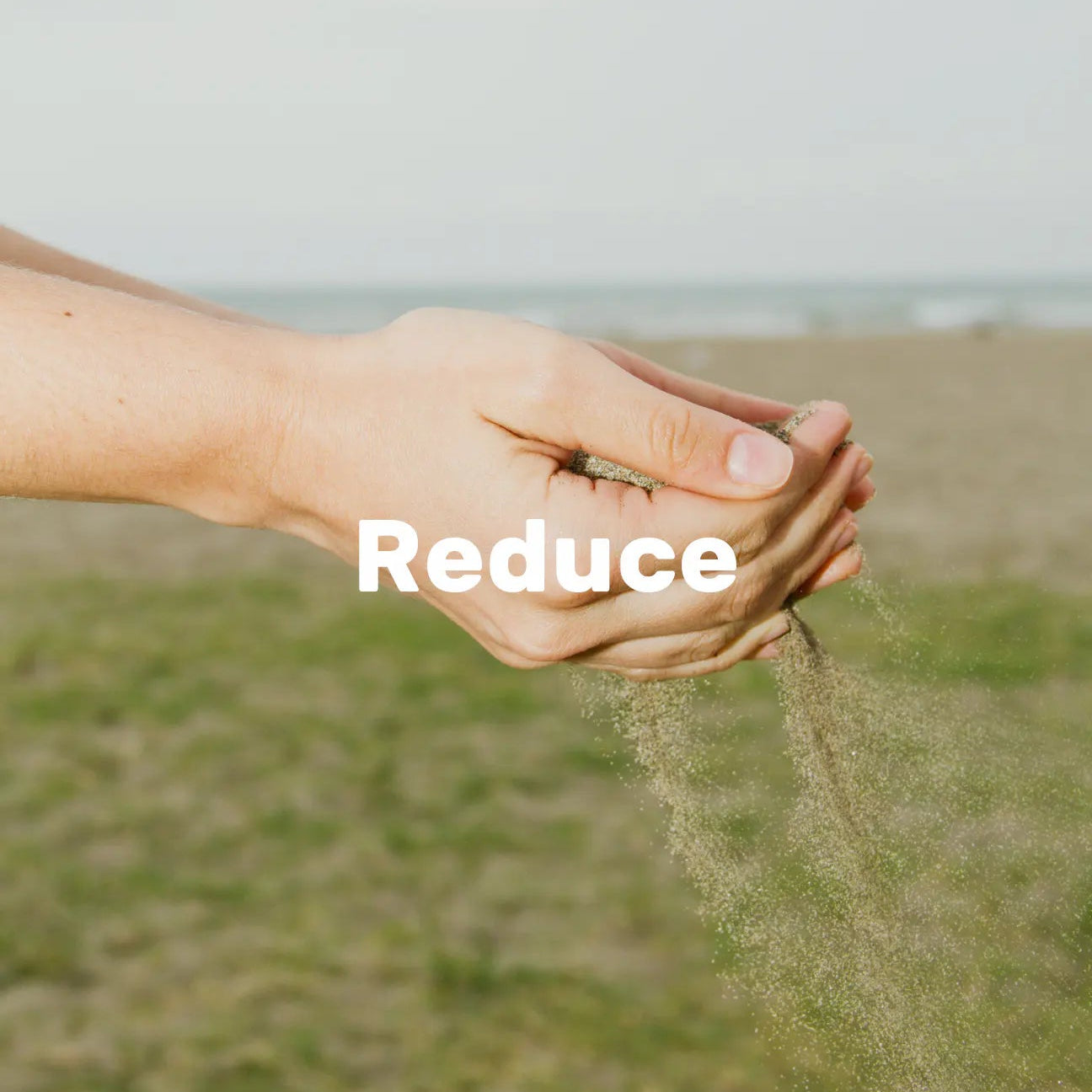 A hand releasing sand with the word "Reduce" superimposed in the center.