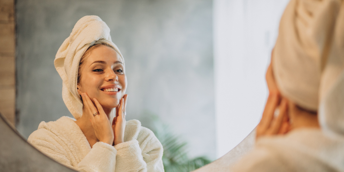women looking at the mirror and doing a spring skin care for radiant skin