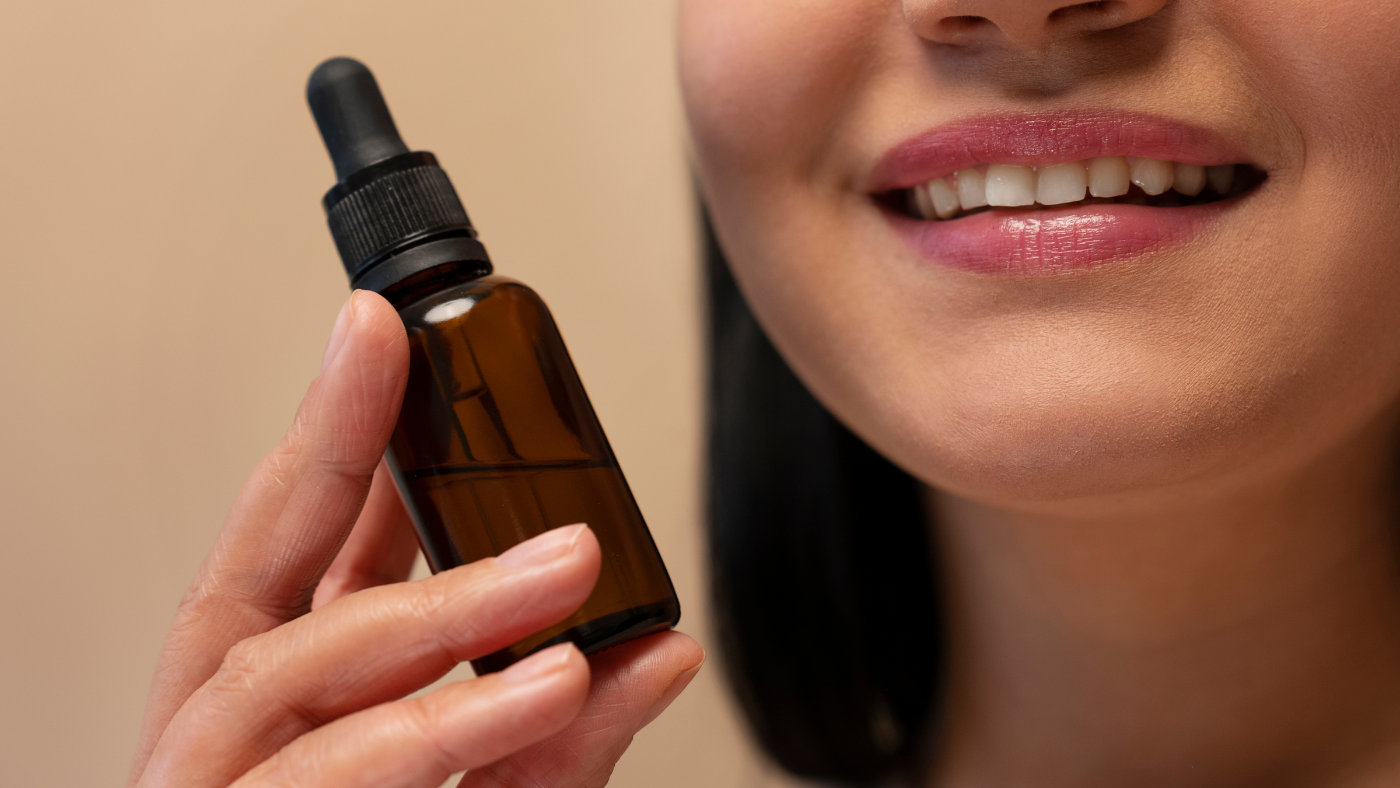 a women holding a bottle of oil for oil pulling to maintain oral care and hygiene