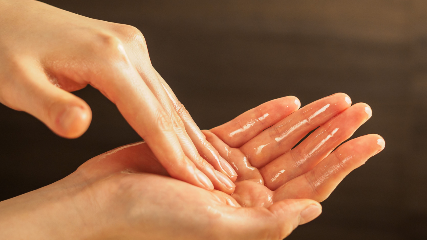 a women spreading an ayurvedic oil for self massage ritual which is called self abhyanga