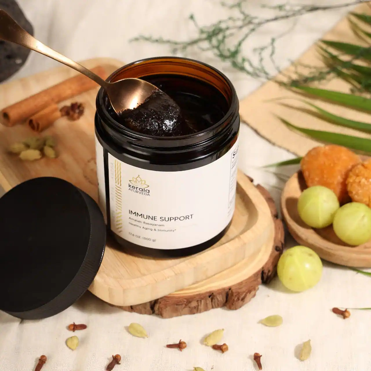 A open jar of Kerala Ayurveda Immune Support, Amalaki Rasayana, with a spoon full of rasayana paste 