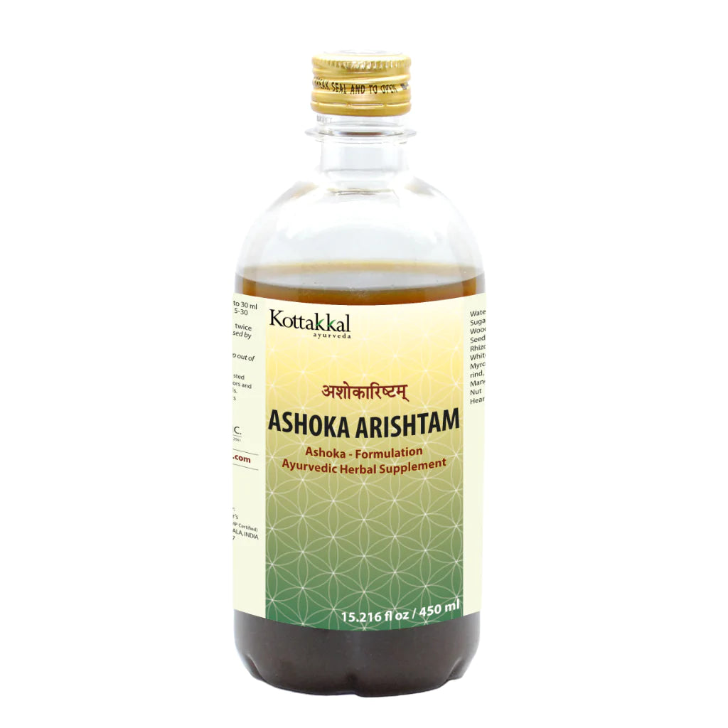 A bottle of KT Ashoka Arishtam, an Ayurvedic herbal supplement by Kottakkal. The label is green and yellow with text and branding.