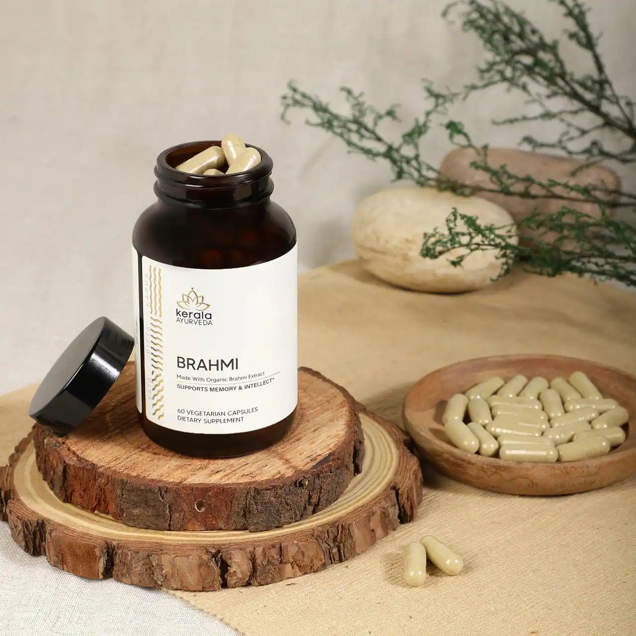 An open bottle of Kerala Ayurveda Brahmi, containing 60 vegetarian capsules, with a tray of capsules placed next to the bottle
