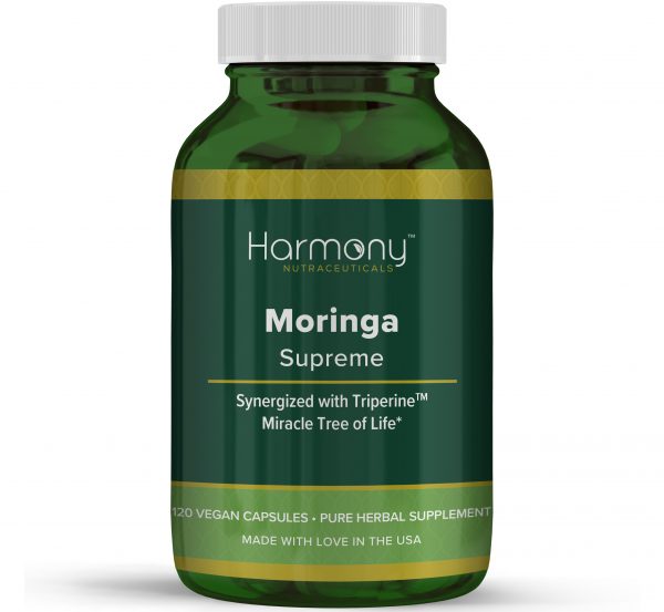 A bottle of Harmony Moringa Supreme herbal supplement with 120 vegan capsules. The bottle is green with a white label.