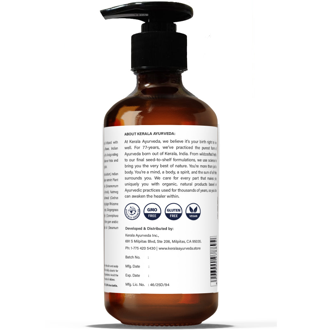 A back view of clear bottle with a pump dispenser, labeled Herbal Skin Oil (Eladi Thailam), with brand details.