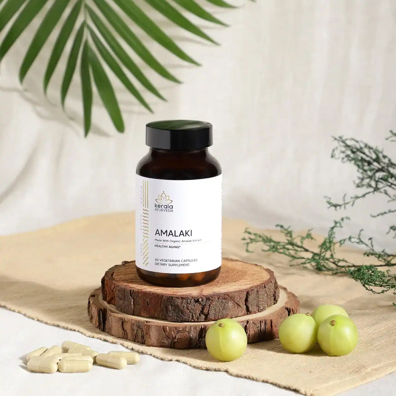 A bottle of Kerala Ayurveda Amalaki dietary supplement with 60 vegetarian capsules, with beige background 