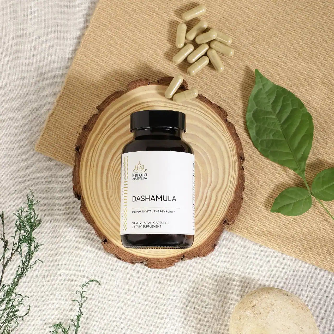 A bottle of Kerala Ayurveda Dashamula with capsules lying next to the bottle