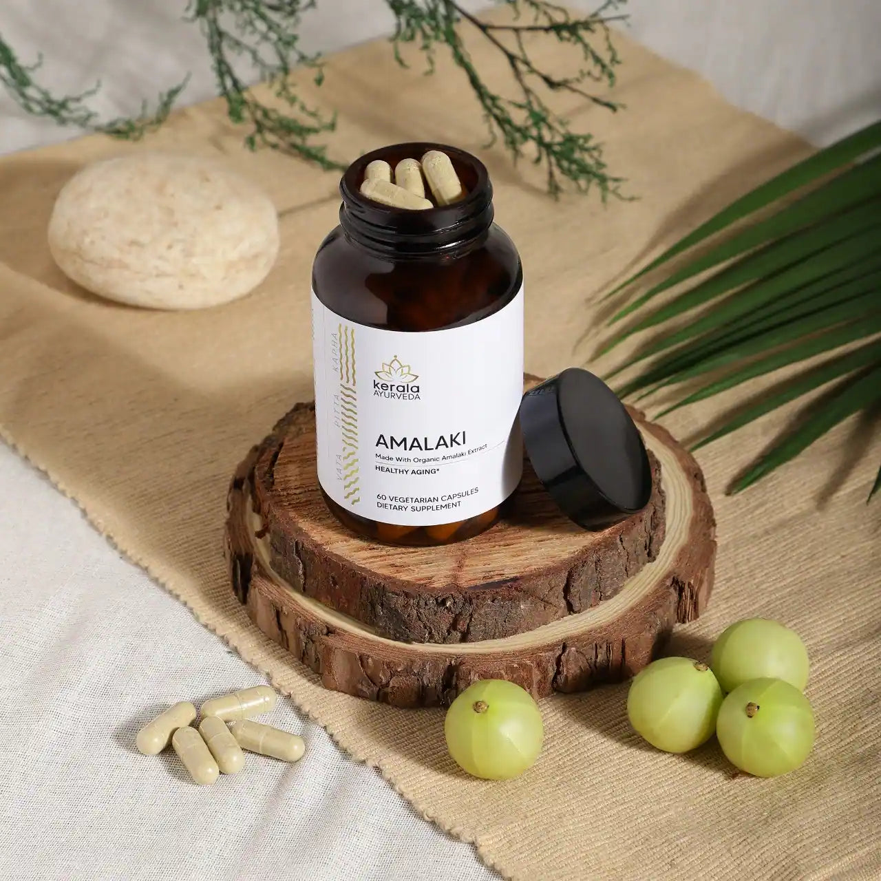 An open bottle of A bottle of Kerala Ayurveda Amalaki dietary supplement with 60 vegetarian capsules
