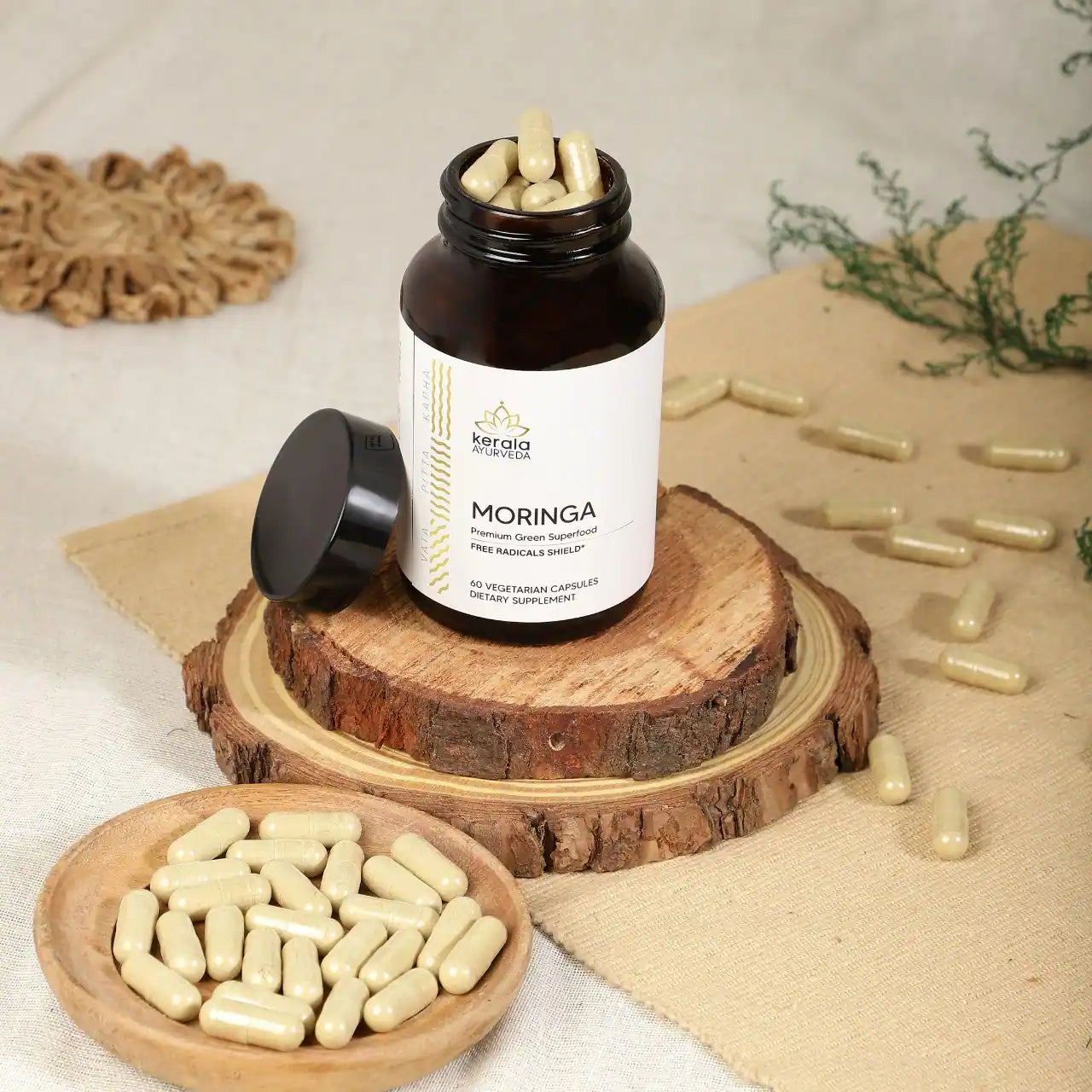 An open bottle of Kerala Ayurveda Moringa dietary supplement with 60 vegetarian capsules.