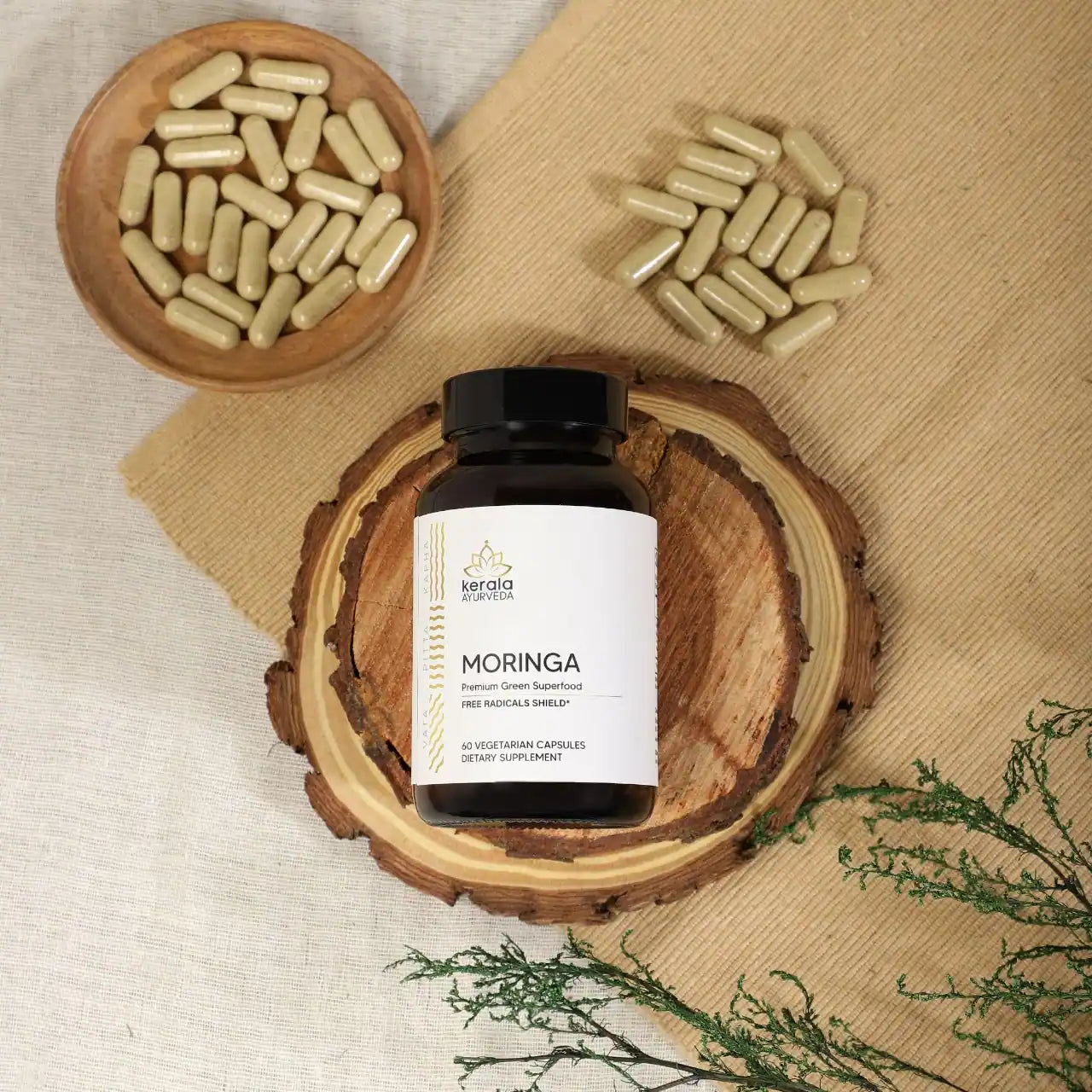 a bottle of moringa capsules with text highlighting the premium green superfood.