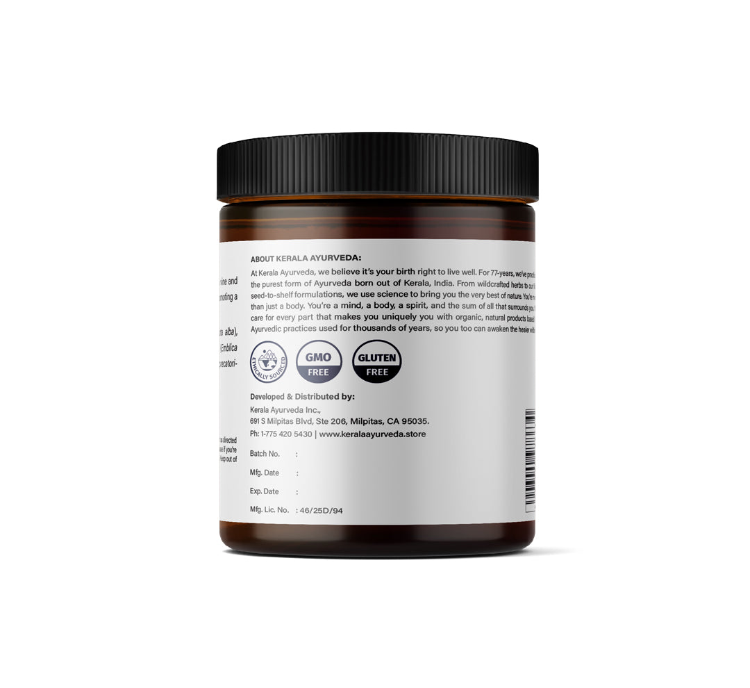 A jar of Revitalizing Hair Oil (Neelibringadi Keram), an ayurvedic hair oil with a white label indicating brand inforamation