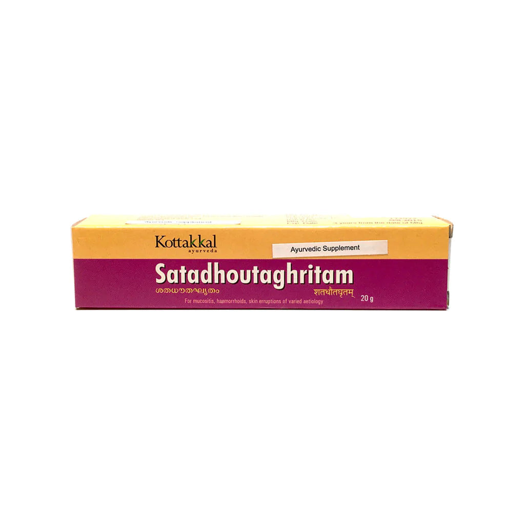 A box of KT Satadhoutaghritam, an Ayurvedic supplement, by Kottakkal. The packaging is primarily purple and yellow with text displaying the product name, brand, and 'Ayurvedic Supplement' tag.