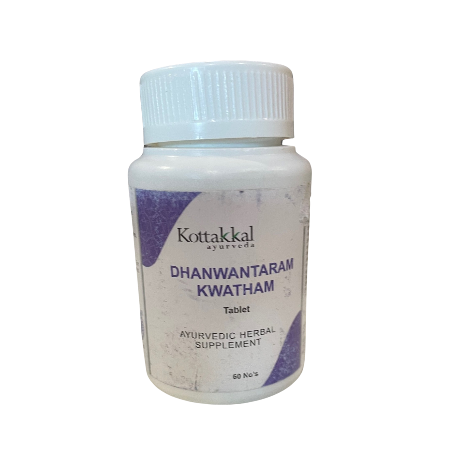 A bottle of KT Dhanwantaram Kwatham herbal supplement tablets by Kottakkal Ayurveda, with 60 tablets inside.